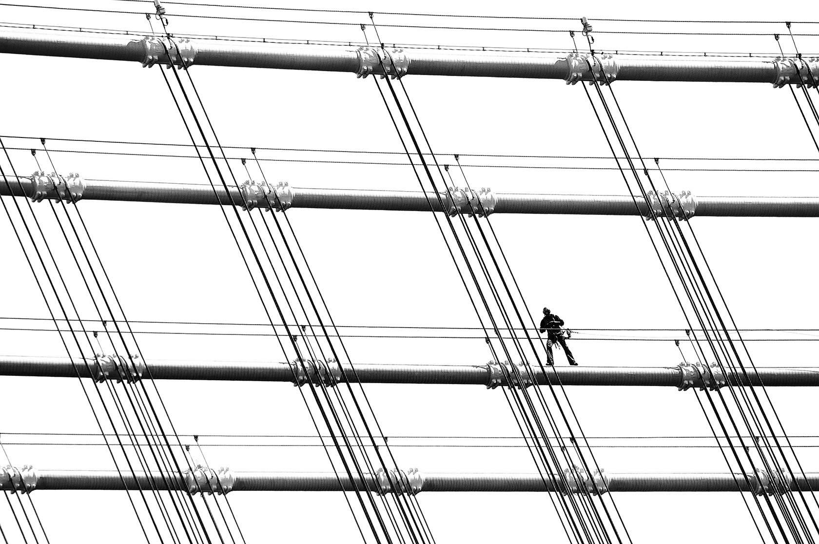 A man working on the Manhattan Bridge, New York City, NY, USA